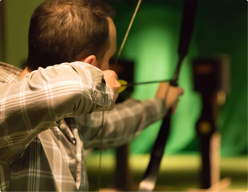 Man Practicing in Indoor Archery Range